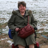 Lynne out in the snow with her wheelchair.