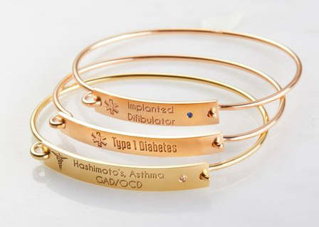 thee gold bangle style bracelets engraved with medical info