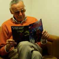 Stan Lee reading Avengers comic book