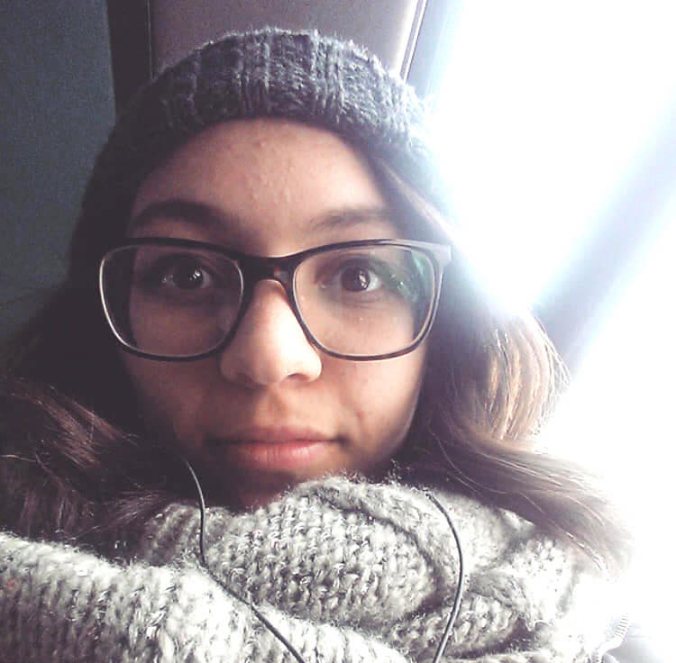 woman in beanie and scarf selfie