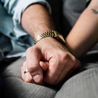 couple holding hands on sofa close up