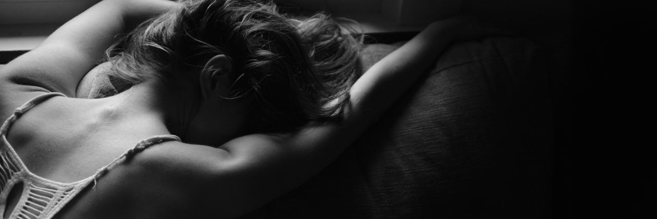 The Hope I Found After Almost Dying by Suicide on Christmas Eve black and white photo of woman leaning on bed