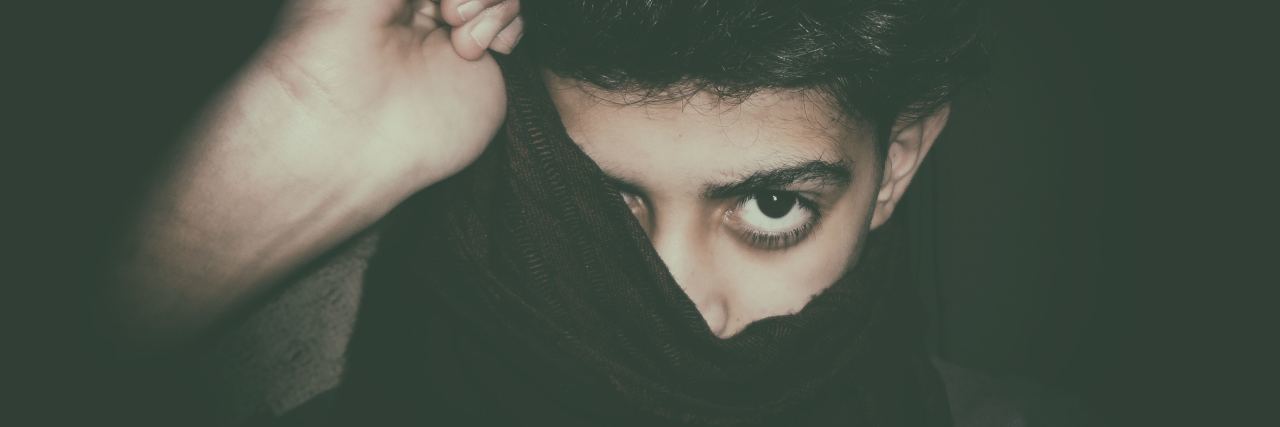 Man's Depression Signs Tweet Goes Viral After His Brother's Suicide A man pulling a dark sweatshirt over his head