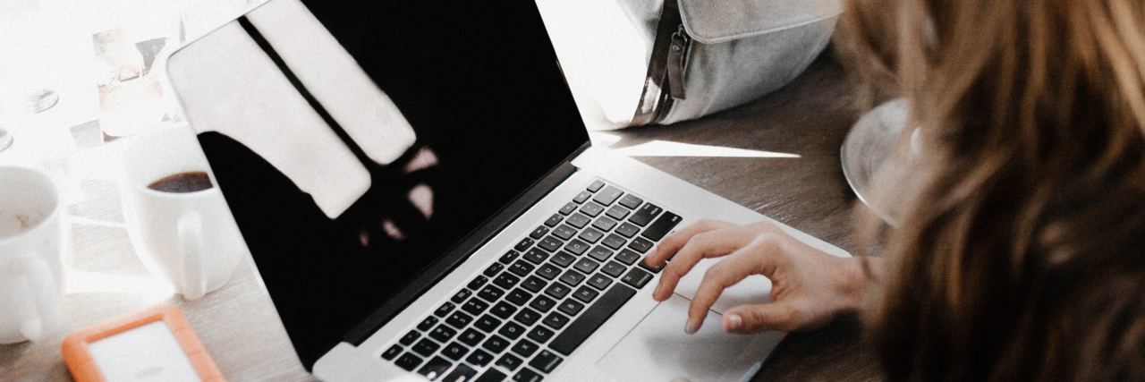 Bipolar Disorder, , mental health, bipolar When You Both Love and Hate Hypomania in Bipolar Disorder woman working on laptop close up over shoulder