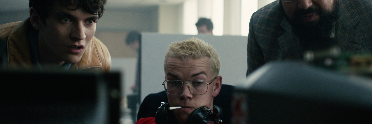 Suicide Content Warning for Netflix's 'Black Mirror: Bandersnatch' Still of Stefan, Colin, and another game company employee staring at a computer screen.