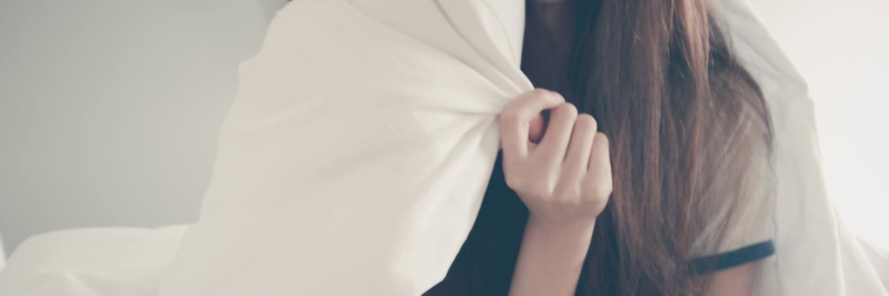 Why I'm Not Using the Label 'High-Functioning' Depression close up of woman wrapped in blanket sitting on bed