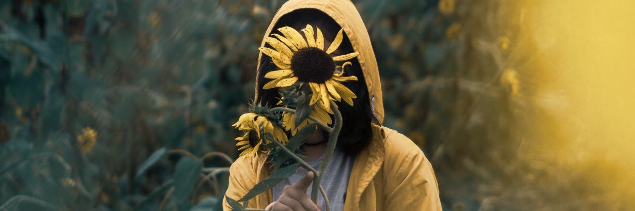'White Lies' People With Mental Illness Tell person covering face with sunflower in field
