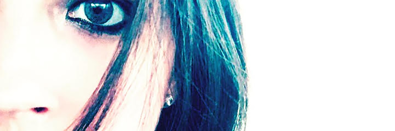 How My Parents' Gaslighting Affected Me as an Adult contributor photo of young woman looking into camera with dark eye makeup