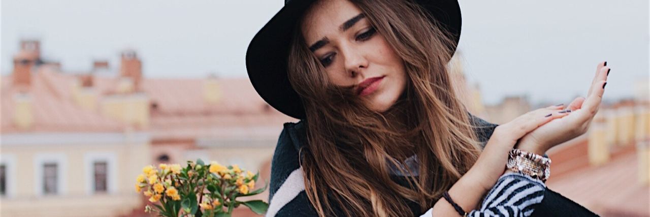 Signs You Are a People-Pleaser woman sitting at table looking down concerned