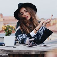 woman sitting at table looking down concerned