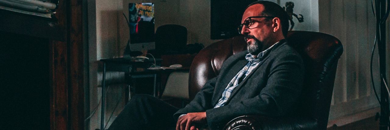 Things I Lost After Surviving My Suicide Attempt middle aged man sitting in chair pensive and thinking