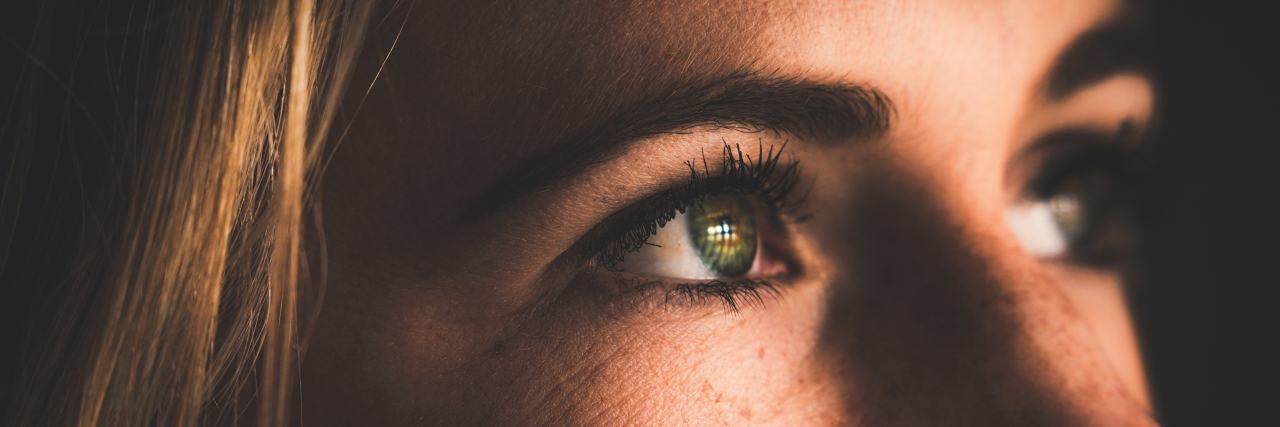 close up of woman's eyes as she's looking up