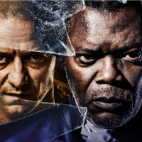 Poster for "Glass." James McAvoy, Samuel L. Jackson and Bruce Willis all standing behind broken glass with serious expressions.