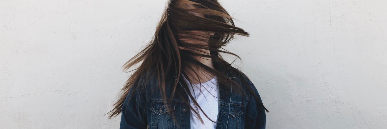 What to Know About Discovering Anxiety as an Adult young woman with hair covering her face turning head fast