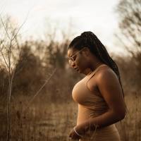 black woman in countryside wearing glasses in profile