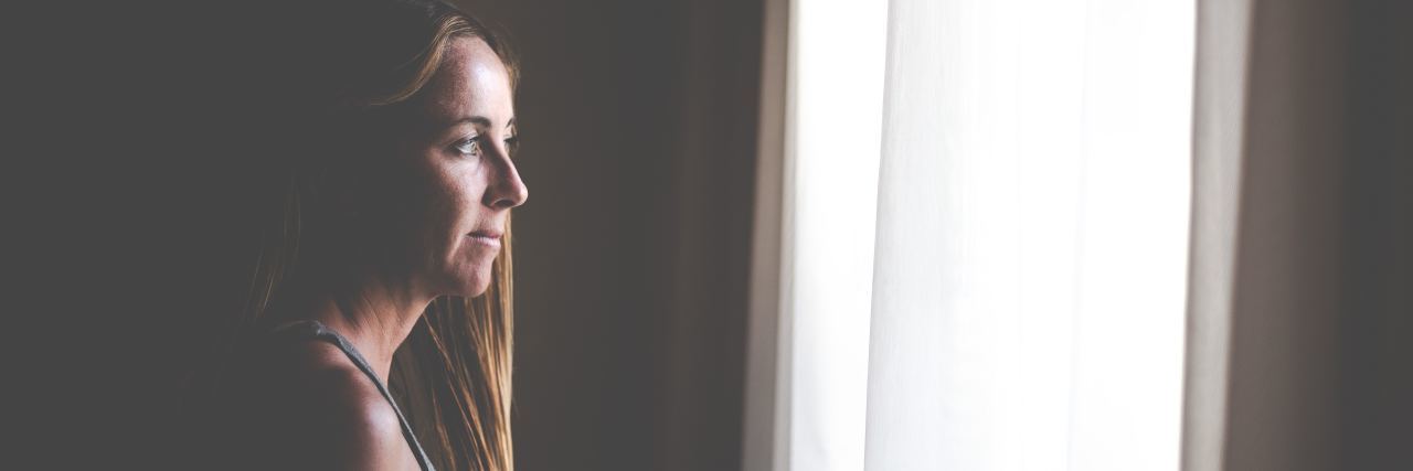 Why Childhood Emotional Neglect Is Actually 'Abuse by Omission' profile view of woman looking out of window