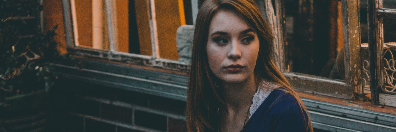 How to Know If Bipolar Depression Is Coming Back Into Your Life woman sat on bench in front of house