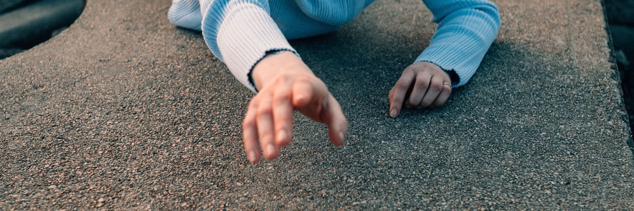 Why I 'Seek Attention' When I'm Depressed A woman reaching up for help