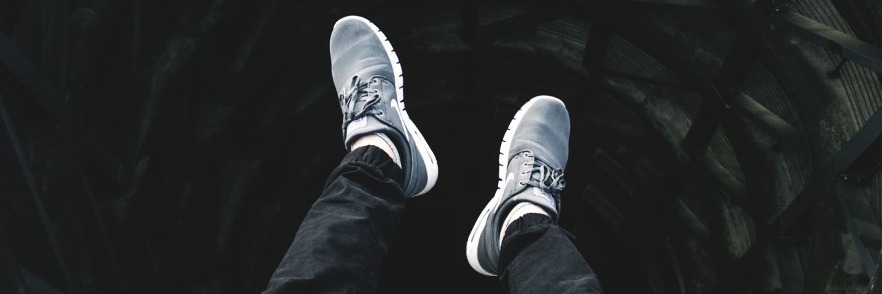 How I Find My Way Through Depression When It Strikes person's legs dangling over hole and darkness like a deep well