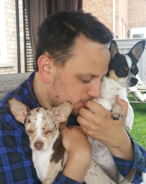 Daniel holding his two Chihuahuas