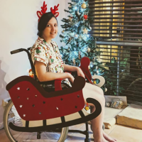 Alexandra in her wheelchair decorated as a sleigh.
