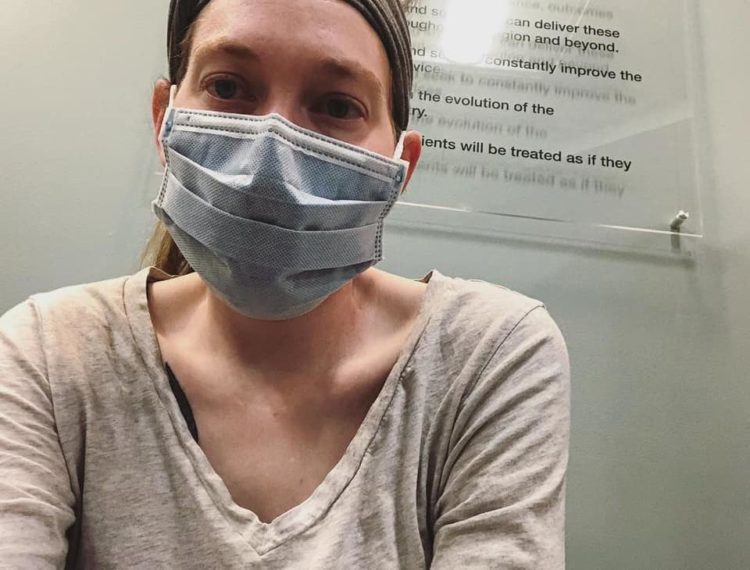 woman wearing a face mask in the doctor's office due to a suppressed immune system