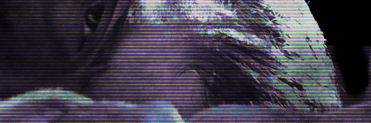 It's OK to Be Alone Sometimes to Help Your Mental Health distorted photo of close up of man's face lying in bed looking into camera