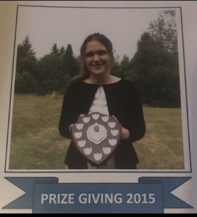 Peri-Ann holding a school award.