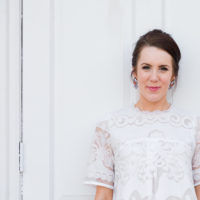 woman in white against a white wall
