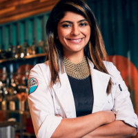 Fatima Ali smiling, wearing 'Top Chef' jacket