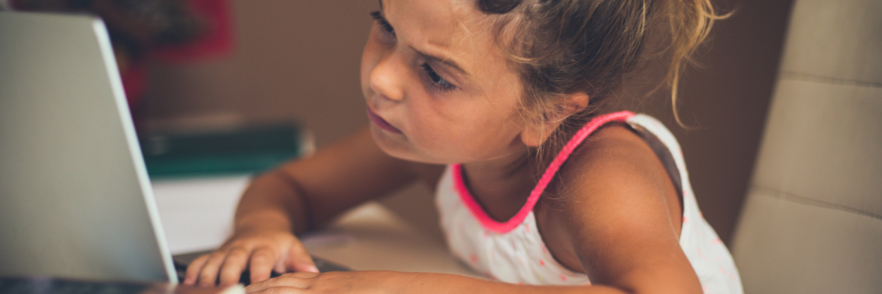 My Parents Hid My ADHD From Me Girl struggling with homework on laptop computer.