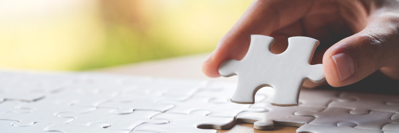 How My Teenage Son Feels About the Autism Puzzle Piece hang holding white puzzle piece