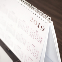 Desktop calendar sitting on desk showing year 2019.