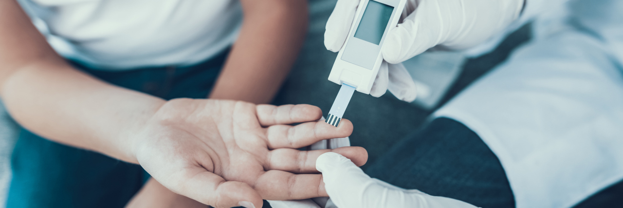 Study Finds Age of Type 1 Diabetes Shows Risk of Autoimmune Disease Doctor Taking Blood Sample from Boy's Finger. Diabetes Concept. Sugar in Blood. Healthcare Concept. Young Man in Uniform. White Coat. Medical Equipment. Boy in Clinic. Glucometer in Hand.