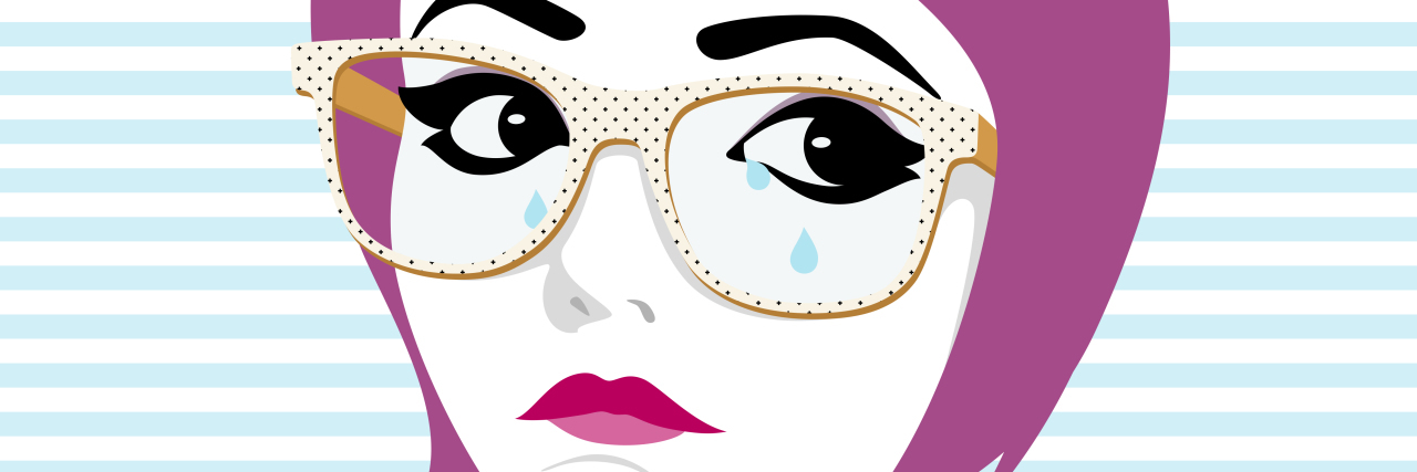 Crying woman with glasses and tears on her face