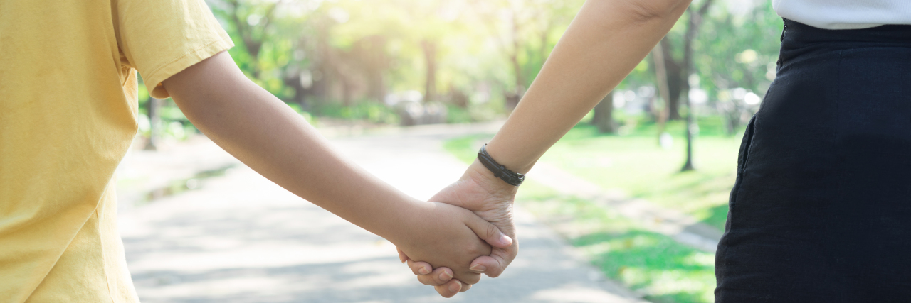 mother holding her son's hand