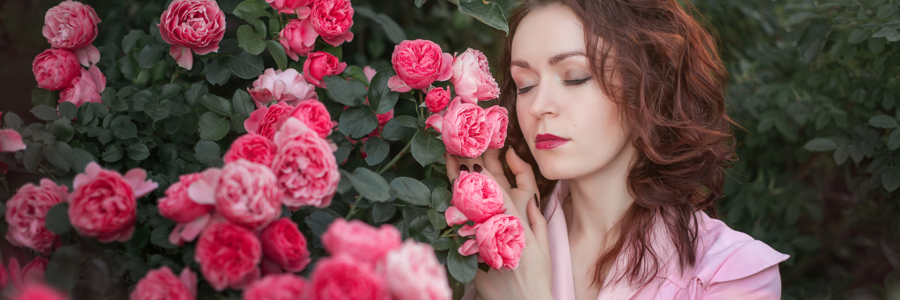 How to Take Care of Neglected Emotions for Your Mental Health photo of woman standing beside pink roses with eyes closed and hands raised to flowers