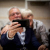 an older couple is taking a selfie