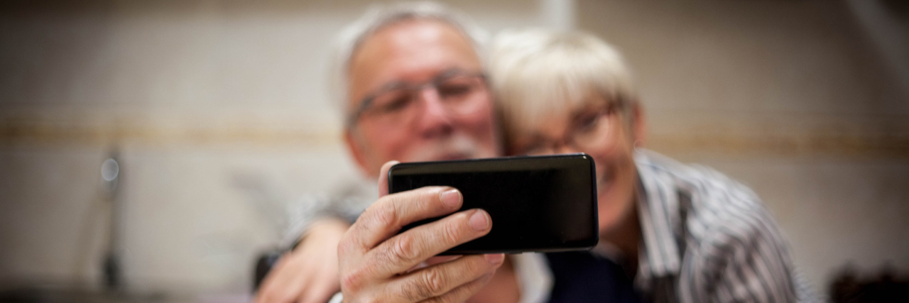 an older couple is taking a selfie