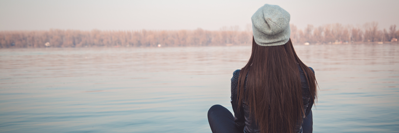 Accepting My Chronic Pain Helped in the Healing Process Girl sitting on pier and looking at river