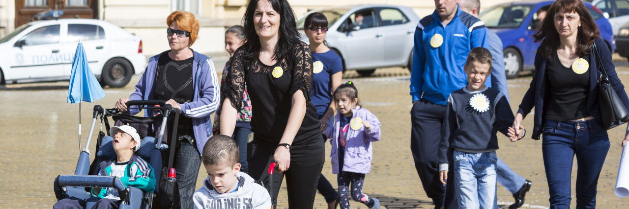 Raising a Child With Phelan-McDermid Syndrome Parents pushing their kids in wheelchairs walking down the street