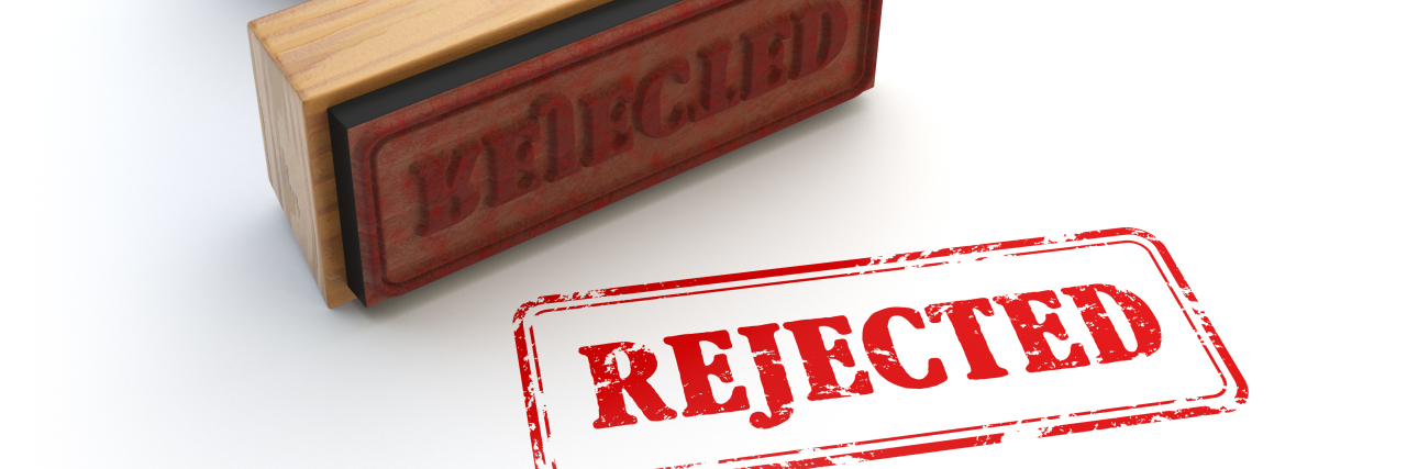 Dealing With Rejection as an Autistic Person Stamp that says Rejected.
