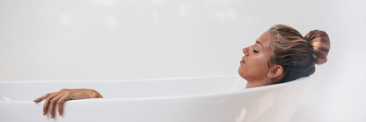 Small Acts of Self-Care Matter With Chronic Pain Woman relaxing in bathtub.