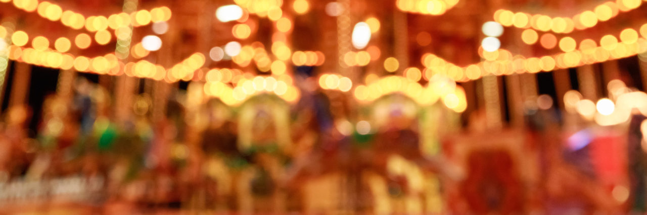 blurred merry-go-round lit up at night