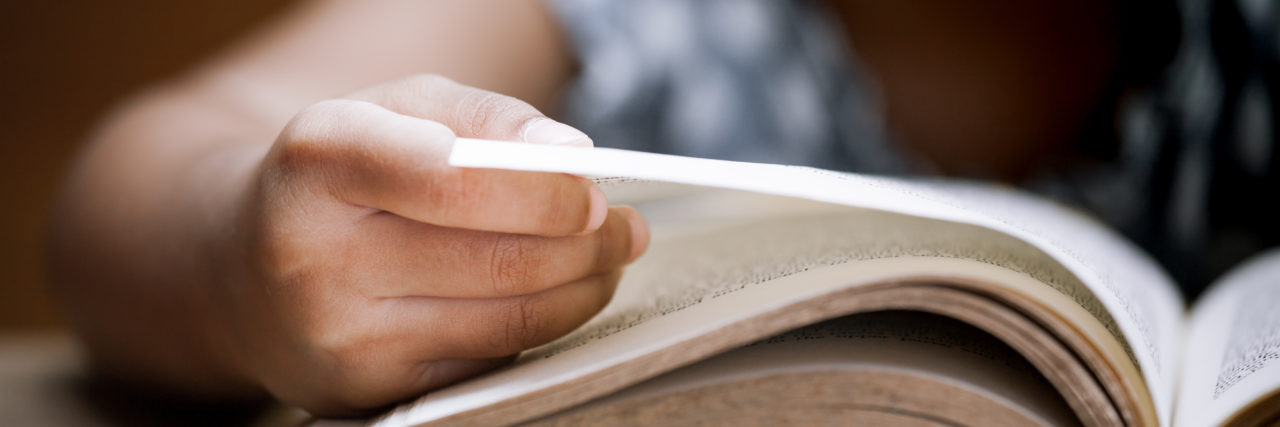 Open Letter to Special Education Teachers From a Student With Autism Child hand opening book.