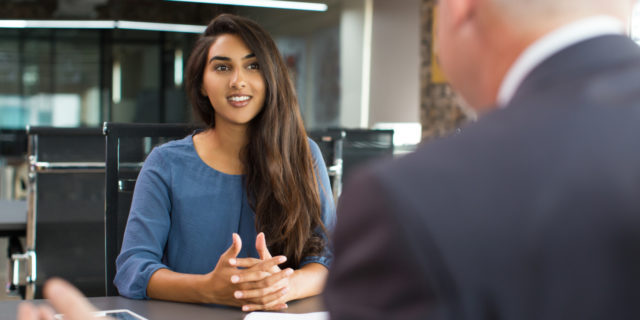 photo of south asian woman meeting man in office and smiling