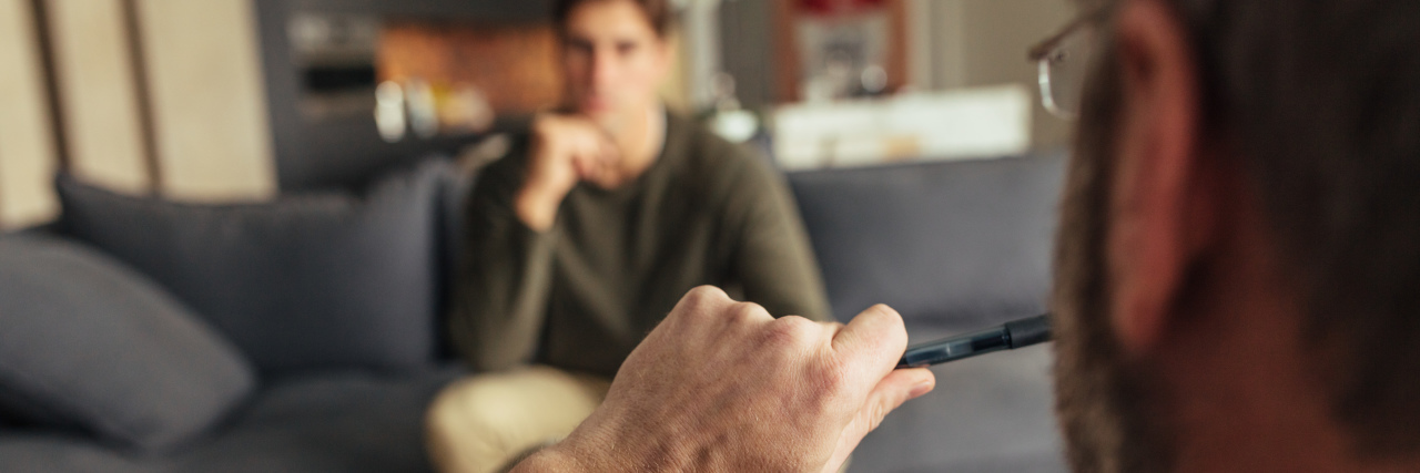 Using Sleuth Empathy as an Autistic Psychotherapist Hands of psychologist holding a pen and listening to man during therapy session.