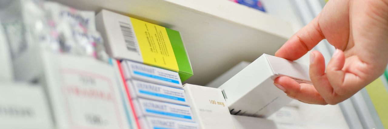 Millions Exposed to Probable Carcinogens in Blood Pressure Medication Closeup pharmacist hand holding medicine box in pharmacy drugstore.