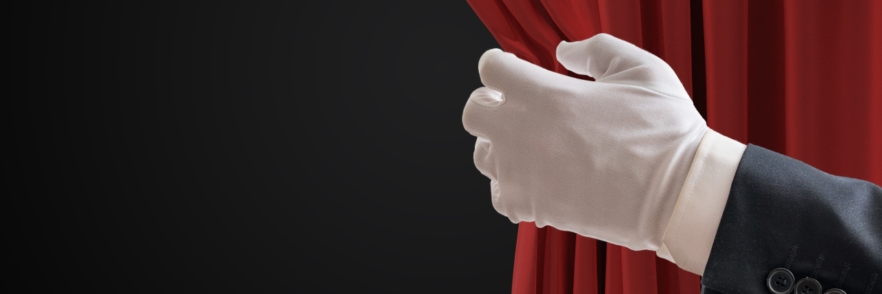 Behind the Curtain of My Life With a Disability Actor with gloved hand pulling back red curtains.