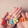 Autism colorful word on hands.